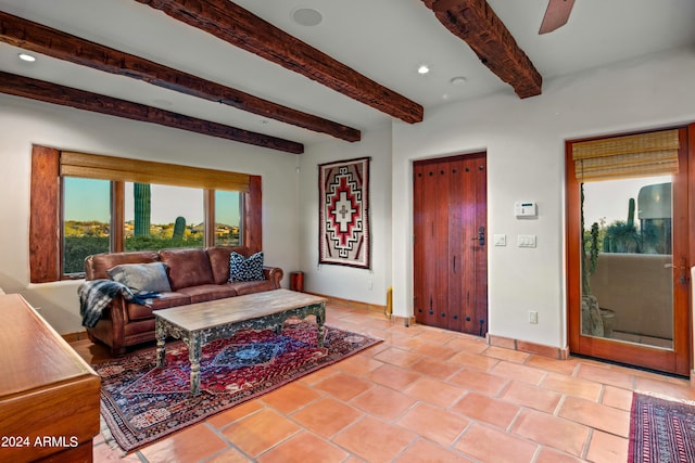 tiled living room featuring ceiling fan and beamed ceiling