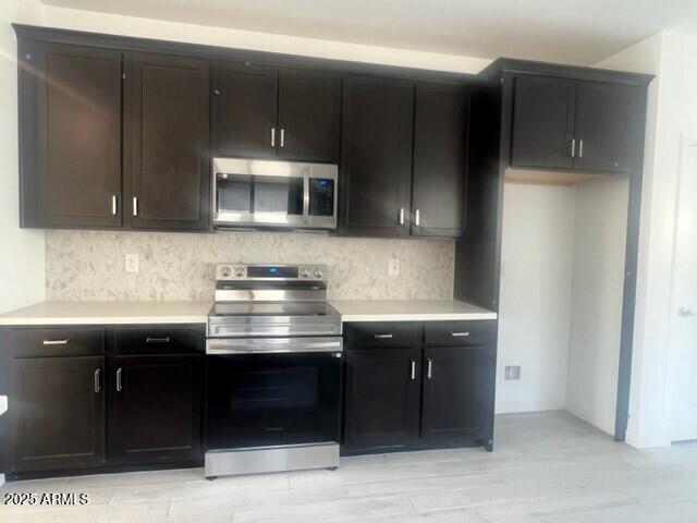 kitchen featuring backsplash and appliances with stainless steel finishes