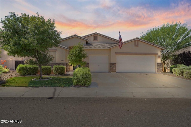 1145 E Winchester Pl, Chandler, AZ 85286 - view of front of property with stone siding, a garage, concrete driveway, and stucco siding