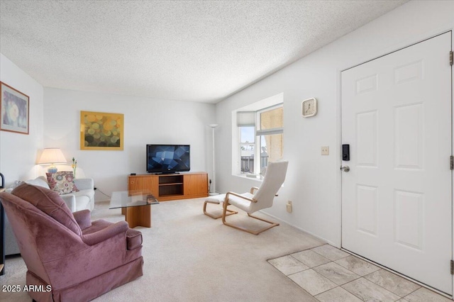 carpeted living room featuring a textured ceiling