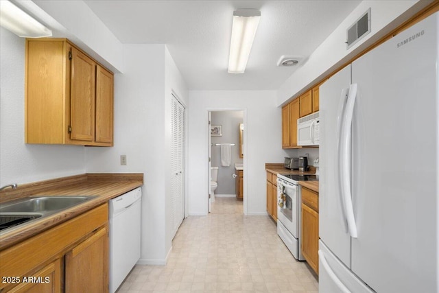 kitchen with white appliances and sink