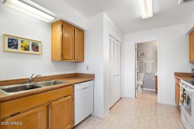 kitchen featuring white appliances and sink