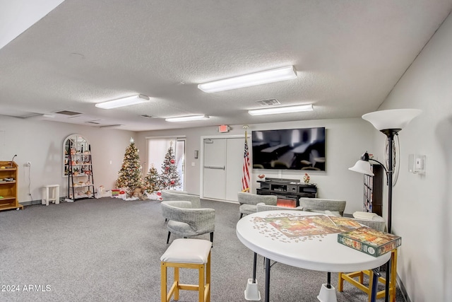 game room featuring carpet floors and a textured ceiling