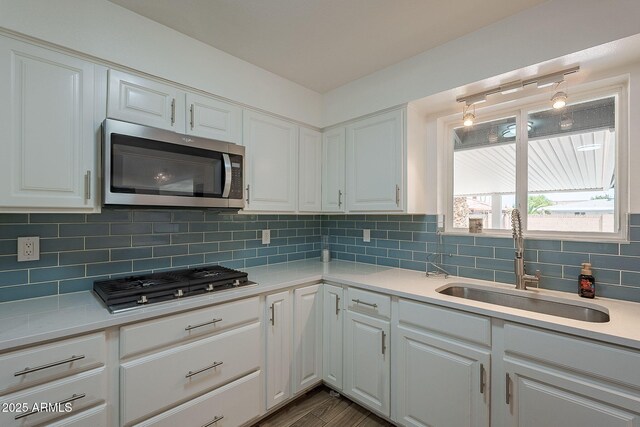 310 E Fremont Dr, Tempe, AZ 85282 - kitchen with appliances with stainless steel finishes, a sink, light countertops, and white cabinets