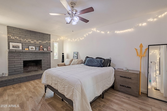 310 E Fremont Dr, Tempe, AZ 85282 - bedroom featuring wood finished floors, a brick fireplace, and ceiling fan