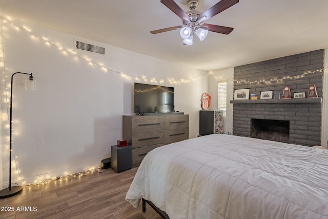 310 E Fremont Dr, Tempe, AZ 85282 - bedroom featuring wood finished floors, a ceiling fan, and a brick fireplace
