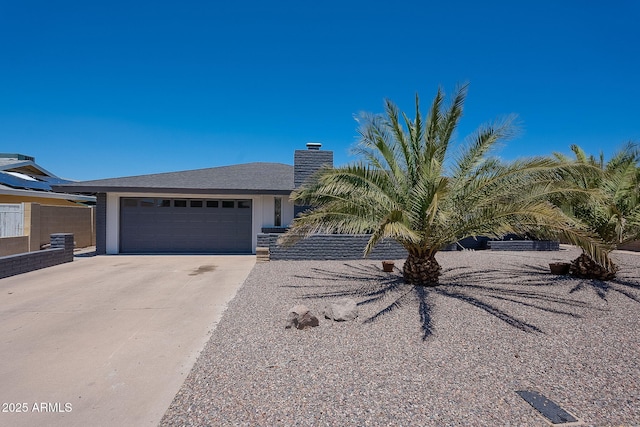 310 E Fremont Dr, Tempe, AZ 85282 - view of front of house with a garage, concrete driveway, and a chimney
