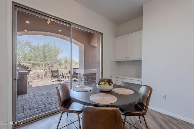 dining room with light wood-style flooring and baseboards
