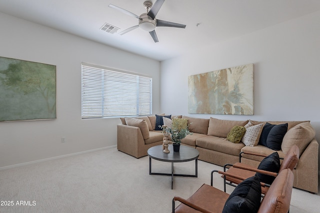 living room featuring ceiling fan, light carpet, and baseboards
