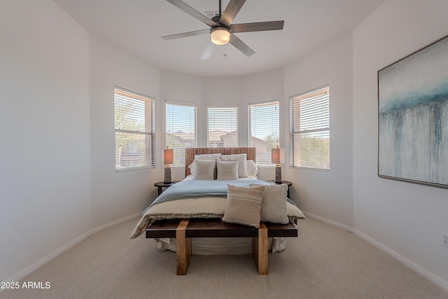 bedroom featuring multiple windows, carpet floors, baseboards, and a ceiling fan