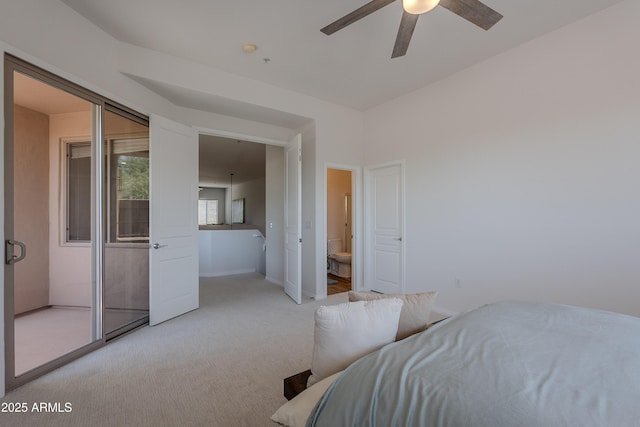 bedroom featuring light colored carpet, baseboards, ceiling fan, and ensuite bathroom