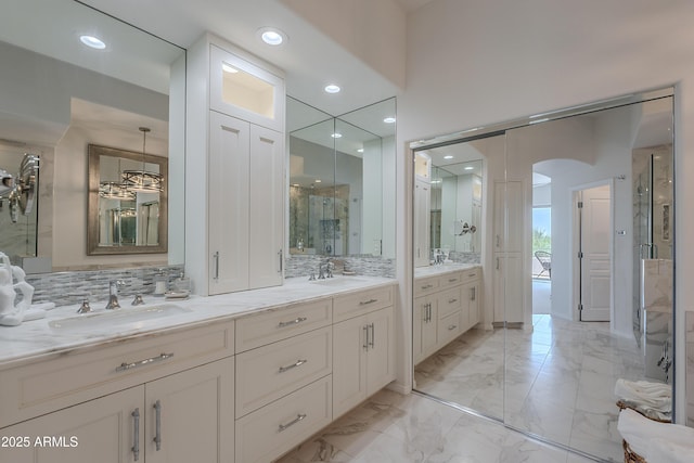 bathroom featuring double vanity, marble finish floors, a stall shower, and recessed lighting
