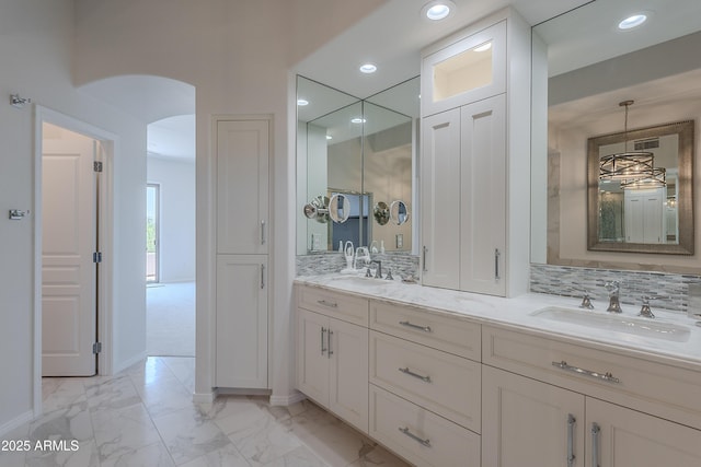 full bath with marble finish floors, recessed lighting, double vanity, and baseboards