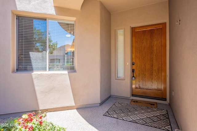 view of exterior entry featuring stucco siding