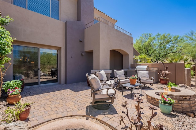 view of patio / terrace with a fire pit and area for grilling