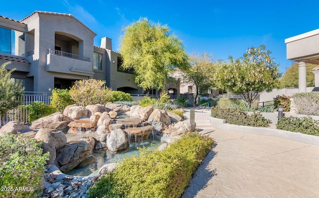 surrounding community with a small pond