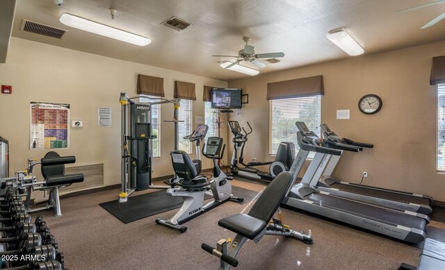 exercise room with a ceiling fan