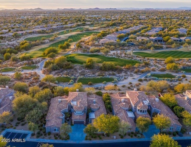 aerial view of a golf course and a mountain backdrop