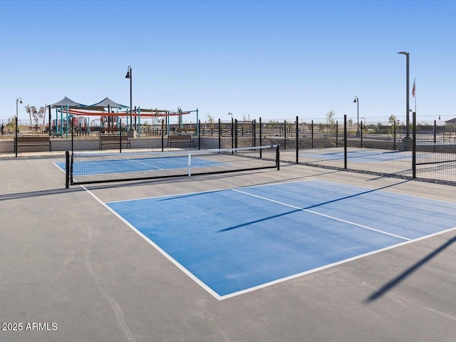 view of sport court featuring fence