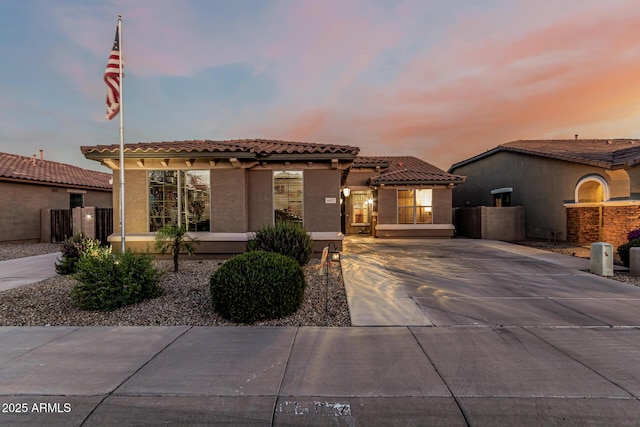 16077 W Anasazi St, Goodyear, AZ 85338 - mediterranean / spanish home featuring stucco siding, a tiled roof, and concrete driveway
