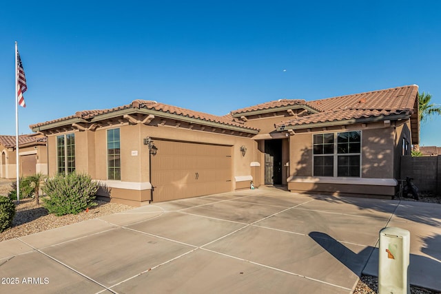 16077 W Anasazi St, Goodyear, AZ 85338 - mediterranean / spanish house with stucco siding, driveway, a garage, and a tile roof
