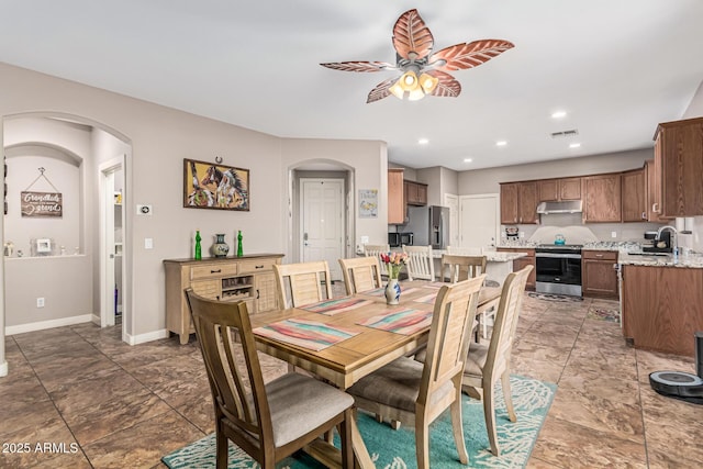 16077 W Anasazi St, Goodyear, AZ 85338 - dining area featuring arched walkways, ceiling fan, and recessed lighting