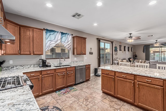 16077 W Anasazi St, Goodyear, AZ 85338 - kitchen with stainless steel dishwasher, a ceiling fan, recessed lighting, and brown cabinets
