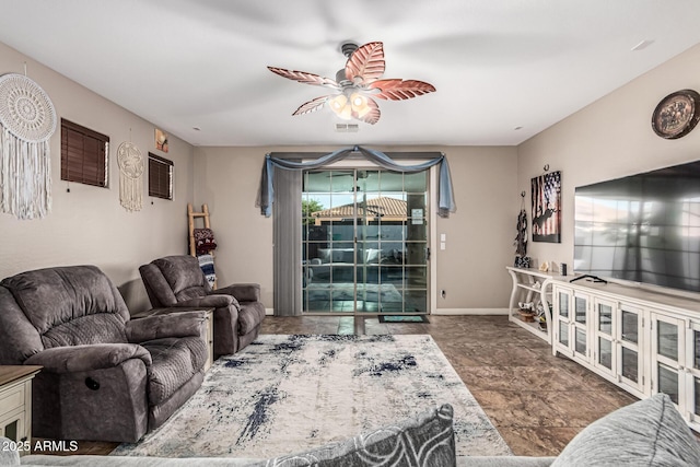 16077 W Anasazi St, Goodyear, AZ 85338 - living room featuring ceiling fan and stone finish floors