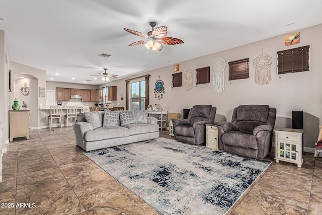 16077 W Anasazi St, Goodyear, AZ 85338 - living room with ceiling fan, arched walkways, and recessed lighting