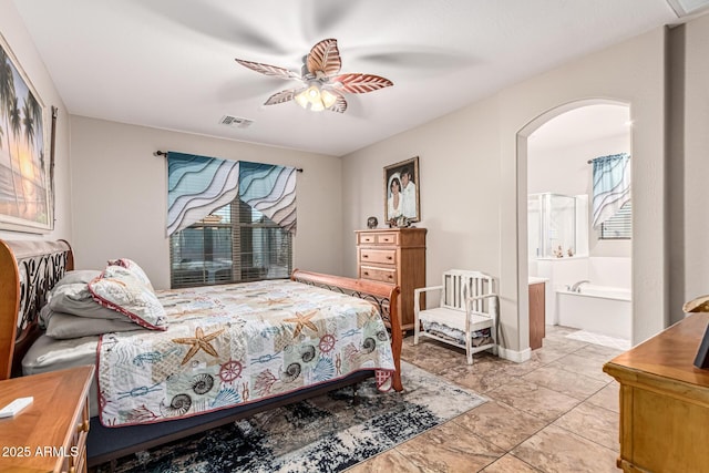 16077 W Anasazi St, Goodyear, AZ 85338 - bedroom with multiple windows, arched walkways, connected bathroom, and a ceiling fan
