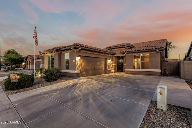 16077 W Anasazi St, Goodyear, AZ 85338 - mediterranean / spanish-style house with a tiled roof, stucco siding, a garage, and driveway
