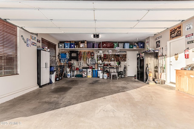 16077 W Anasazi St, Goodyear, AZ 85338 - garage featuring a garage door opener and a workshop area
