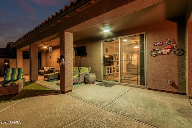 16077 W Anasazi St, Goodyear, AZ 85338 - patio terrace at dusk with outdoor lounge area and a patio