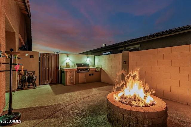 16077 W Anasazi St, Goodyear, AZ 85338 - view of patio / terrace with an outdoor fire pit and an outdoor kitchen