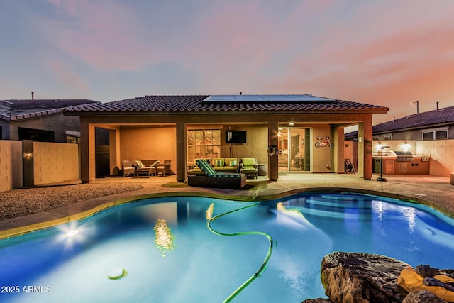 16077 W Anasazi St, Goodyear, AZ 85338 - view of pool with exterior kitchen, outdoor lounge area, ceiling fan, and a patio area