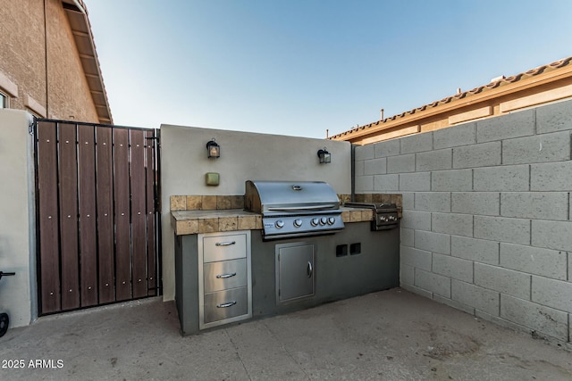 16077 W Anasazi St, Goodyear, AZ 85338 - view of patio / terrace featuring exterior kitchen and a gate