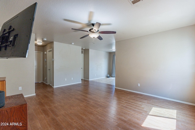 unfurnished living room featuring hardwood / wood-style floors and ceiling fan