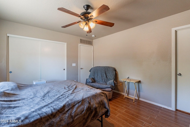 bedroom featuring a closet, ceiling fan, and dark hardwood / wood-style flooring