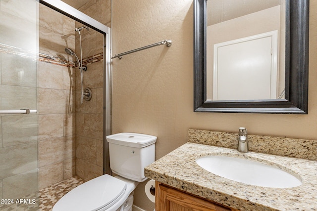 bathroom featuring vanity, toilet, and an enclosed shower