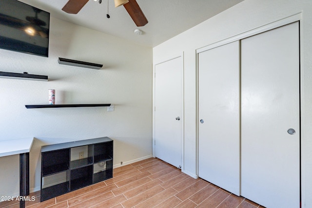 unfurnished bedroom with ceiling fan and light hardwood / wood-style flooring