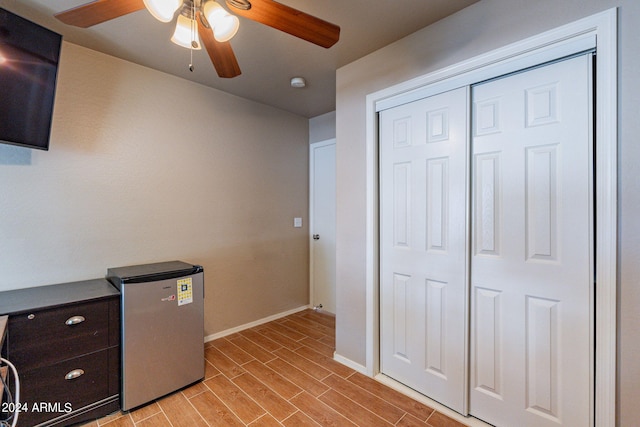 office with light hardwood / wood-style floors and ceiling fan