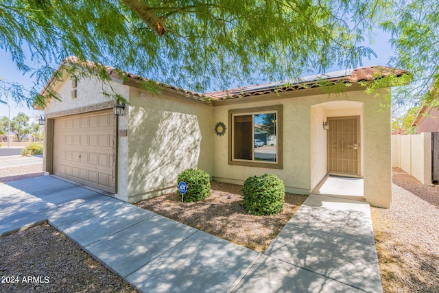 mediterranean / spanish-style home with a garage