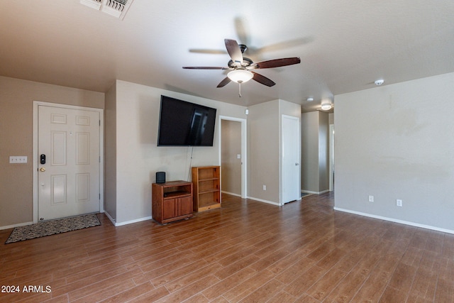 unfurnished living room with wood-type flooring and ceiling fan