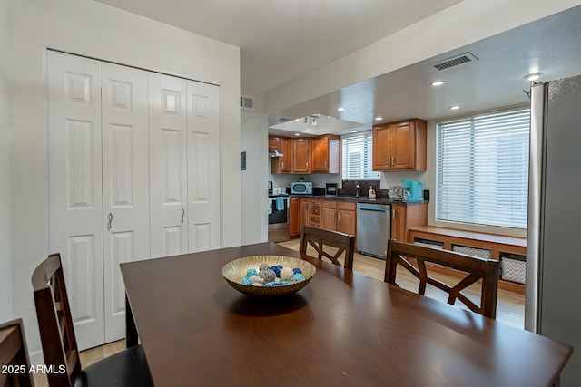 dining space with light wood-type flooring and sink