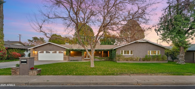 ranch-style home with a garage and a lawn