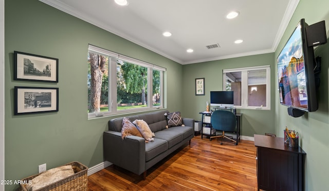 home office with ornamental molding and hardwood / wood-style floors