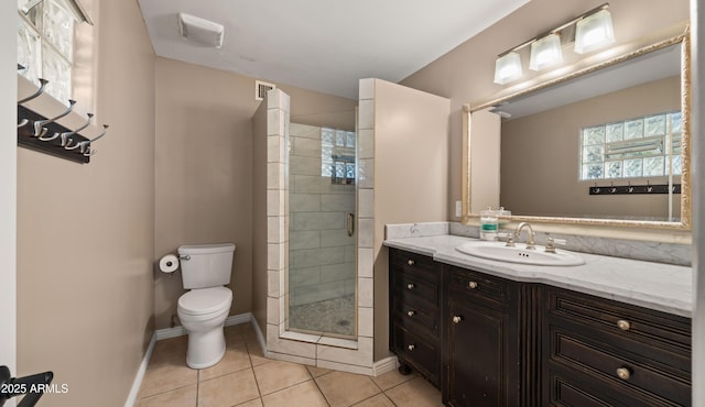 bathroom with toilet, tile patterned flooring, a shower with door, and vanity