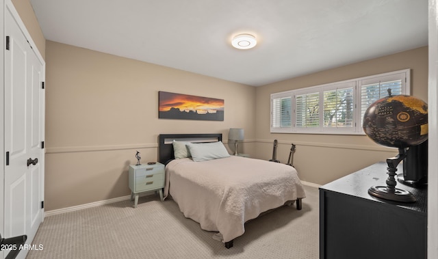 bedroom with light colored carpet and a closet