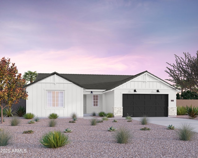 modern inspired farmhouse featuring board and batten siding, an attached garage, and concrete driveway