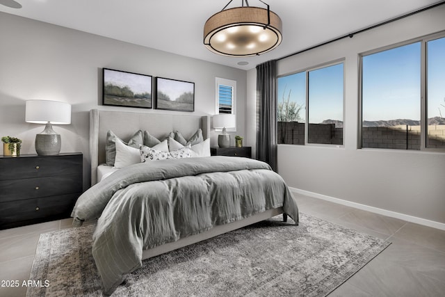 tiled bedroom featuring baseboards